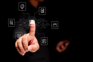 A hand interacting with digital icons, symbolizing data management and technology, against a dark background.