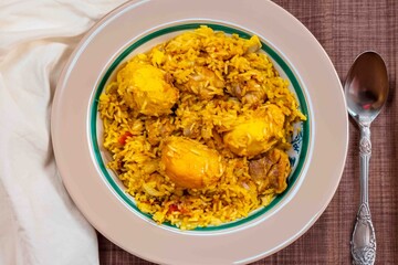 Traditional Brazilian dish of rice, chicken, and pequi ,caryocar brasiliense, known as Goiana chicken stew.	