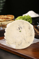 Traditional Chinese Flatbread with Dried Vegetables on Wooden Cutting Board