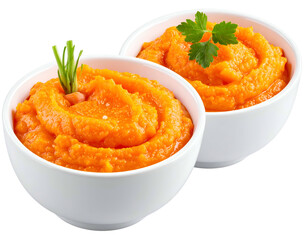 Two white bowls filled with bright orange puree, garnished