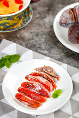 Fresh Sliced Persimmons with Mint Garnish - Nutritious Seasonal Fruit Rich in Vitamins