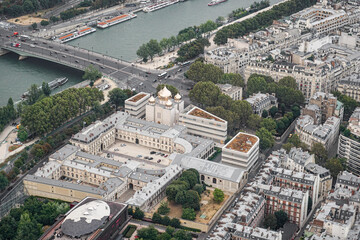 Fototapeta premium An aerial view of a part of the city of Paris, showing an Orthodox Christian church The church has golden domes, and the streets and the river are visible