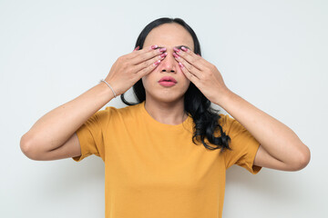 Portrait of a young Thai transgender person against white background covering eyes