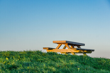 A bench in the park under the sunset.