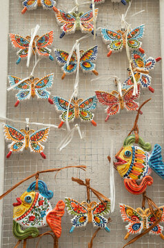 Colorful glazed ceramic fish and butterflies, souvenirs from ols town Lecce, Italy