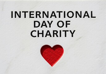 International day of charity text with red heart