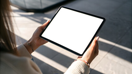 Person Holding Tablet with Blank White Screen in Sunlight hands blank screen