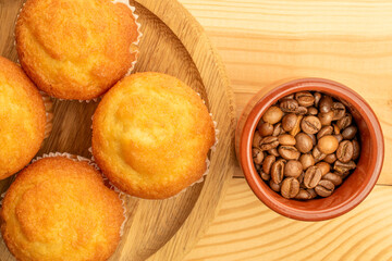 Delicious muffins  on a wooden table, top view, close-up.