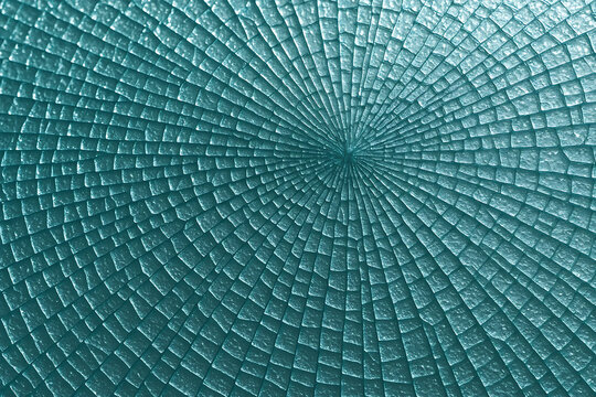 Cracked glass with a radial pattern in shades of blue and teal - Powered by Adobe