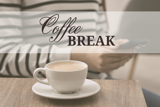 Coffee break time. Woman using smartphone at table with cup of cappuccino, closeup