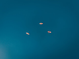 Above of wooden rowboats floating on blue lake in Pragser Wildsee at Lago di Braies, Italy
