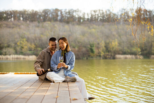 Couple enjoys a romantic moment by the serene lake during a sunny afternoon