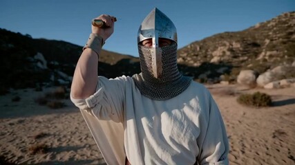 Medieval knight stands with sword, evokes courage and history, desert landscape suggests adventure or battle scene, suitable for Halloween or medieval festivals