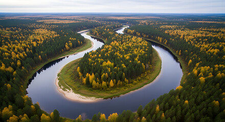 Aerial view of a winding river surrounded by dense forest with autumn foliage under a cloudy sky