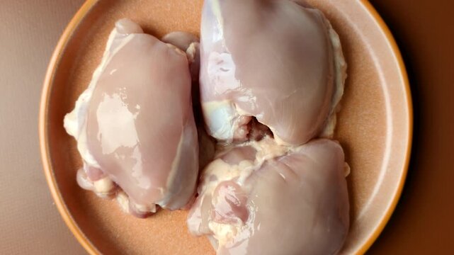 Chicken thigh fillet, skinless and boneless meat for grilling or barbecue. Chicken thigh fillet