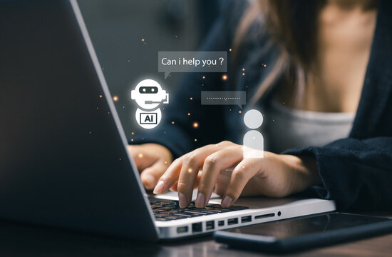 Woman using laptop with AI chatbot assistance on screen. Concept of artificial intelligence, customer support automation, virtual assistant, and digital communication technology.