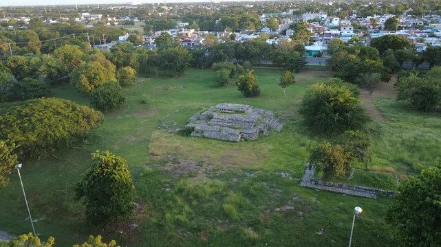 Aerial view of ancient Mayan ruins surrounded by greenery in M&eacute;rida, Yucat&aacute;n, Mexico, captured at sunset