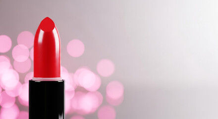 Closeup of red lipstick with black tube on blurred bokeh background, beauty and glamour concept with copy space for text