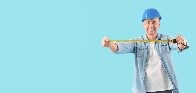 Male engineer with tape measure on blue background with space for text - Powered by Adobe