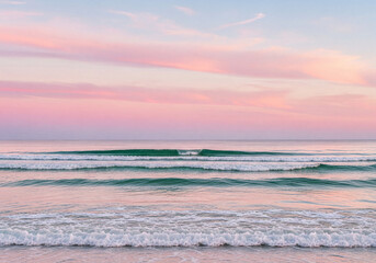 Ocean waves at sunrise with soft pink and blue sky and subtle clouds graphic design