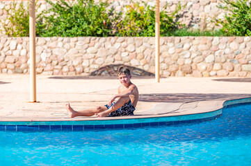 A boy near a pool at a hotel in Egypt