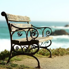 Old wooden bench overlooks the serene ocean with crashing waves.