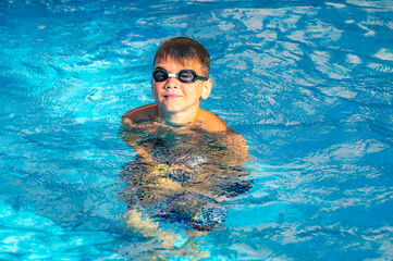 happy boy swimming in the pool