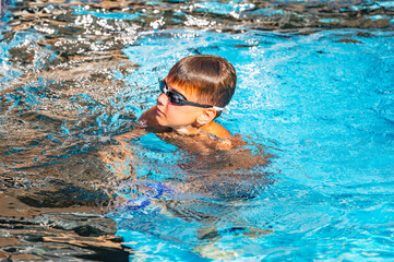 happy boy swimming in the pool