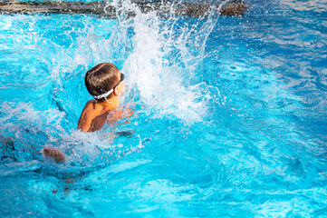 happy boy swimming in the pool