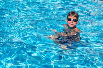 happy boy swimming in the pool