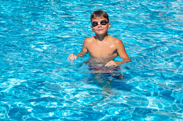 happy boy swimming in the pool