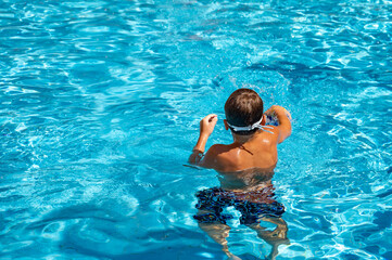 happy boy swimming in the pool