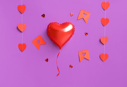 Heart shaped air balloon and garland on purple background. Valentine's day celebration - Powered by Adobe