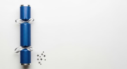 Blue holiday cracker with stars on a plain white background