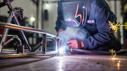Craftsman welding metal frame with sparks flying in workshop, showcasing skill and precision in manufacturing, ideal for engineering and industrial projects, dynamic action