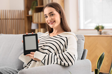 Young girl with e-reader at home