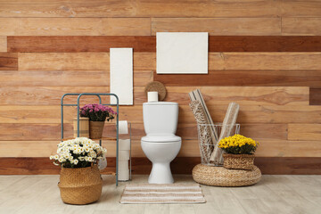 Interior of restroom with toilet bowl and chrysanthemum flowers