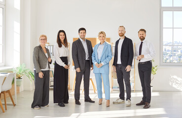 Happy diverse confident hr professional business team portrait standing in office looking at camera, smiling workers, staff group posing together for human resource welcome, corporate equality
