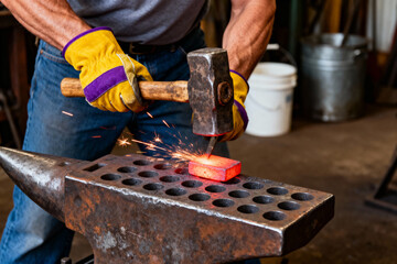 Blacksmith hammering glowing metal on an anvil, sparks flying in a workshop