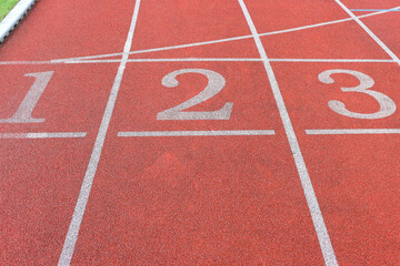 Red running track with white marking lines.