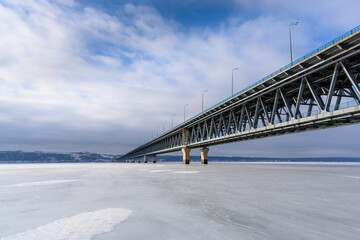 Presidential Bridge close-up against the backdrop of endless ice at the widest point of the Volga River near Ulyanovsk.