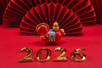 Lunar New Year 2026. New Year background. Red Paper Fans and Horse Figurine