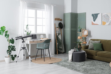 Interior of light room with telescope, workplace and sofa