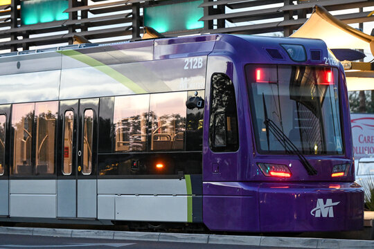 Close-up of Valley Metro light rail train at passenger platform, highlighting commuter transit vehicle design and regional public transportation infrastructure during service operation