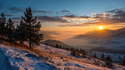 Naklejka premium Stunning winter landscape with bright orange and golden sunset rays breaking through clouds over snow-covered mountain ranges, pine trees on foreground slope, misty valley below, blue sky.