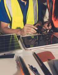 Closeup of team of industrial engineers meeting analyze machinery blueprints consult project on...