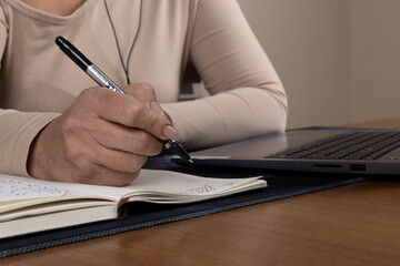 The journalist is diligently taking notes for an upcoming news report