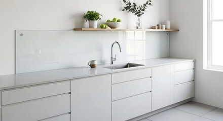 Fototapeta premium Modern minimalist white kitchen with marble countertops and sink.