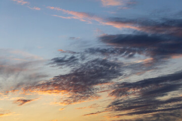 The sky is filled with clouds and the sun is setting