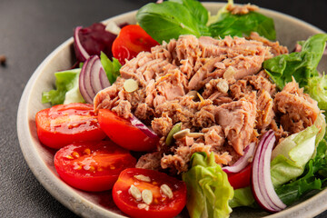 Tuna salad canned fish, tomato, green leaf salad vegetable dish tasty snack fresh gourmet food background on the table rustic top view copy space keto and paleo diet vegetarian food pescetarian diet